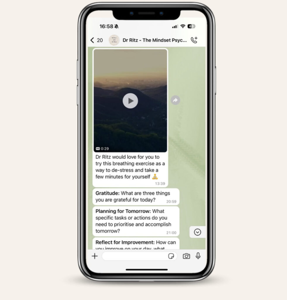 A phone showing Reflect with Dr. Ritz messages on WhatsApp